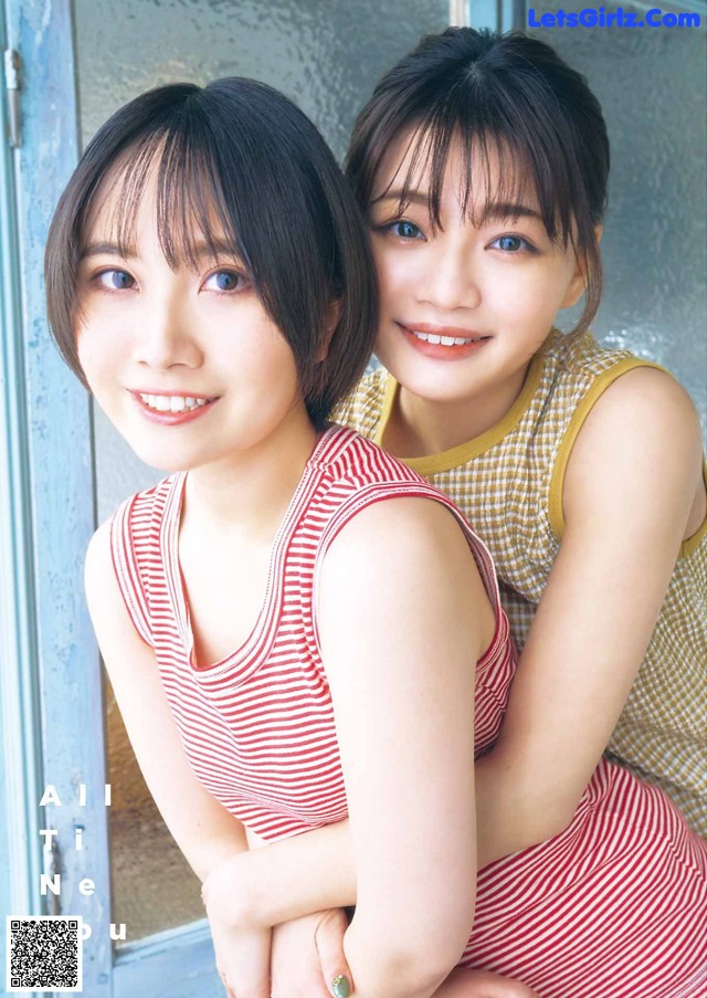 A couple of young women sitting next to each other.