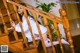 A woman in a white dress is sitting on the stairs.