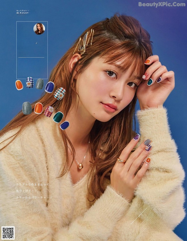 A woman in a white sweater is posing for a magazine.