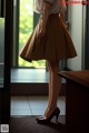 A woman standing in front of a glass door.