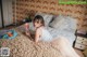 A woman laying on a bed holding a popsicle.