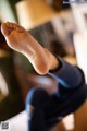 A close up of a person's foot on a bed.