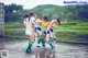 A group of young women playing soccer in the water.