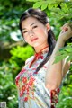 A woman in a cheongsam posing for a picture.