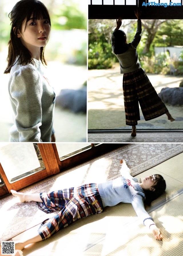 A woman laying on the floor in front of a window.